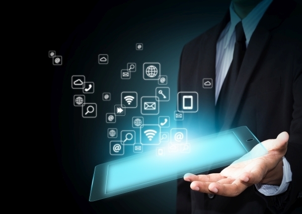 Hand holding touch pad with icons